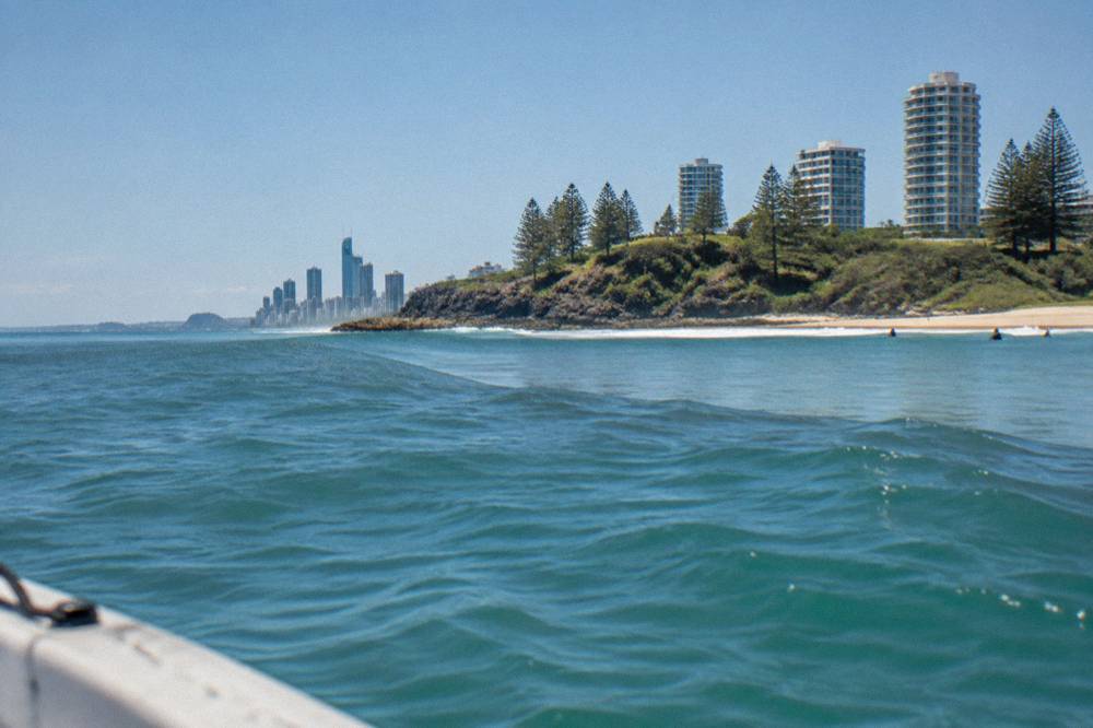 A smooth oval patch of calm water among wind-textured ocean waves