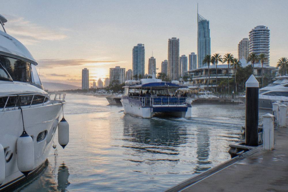 A whale watching vessel leaving the Main Beach marina in soft morning light