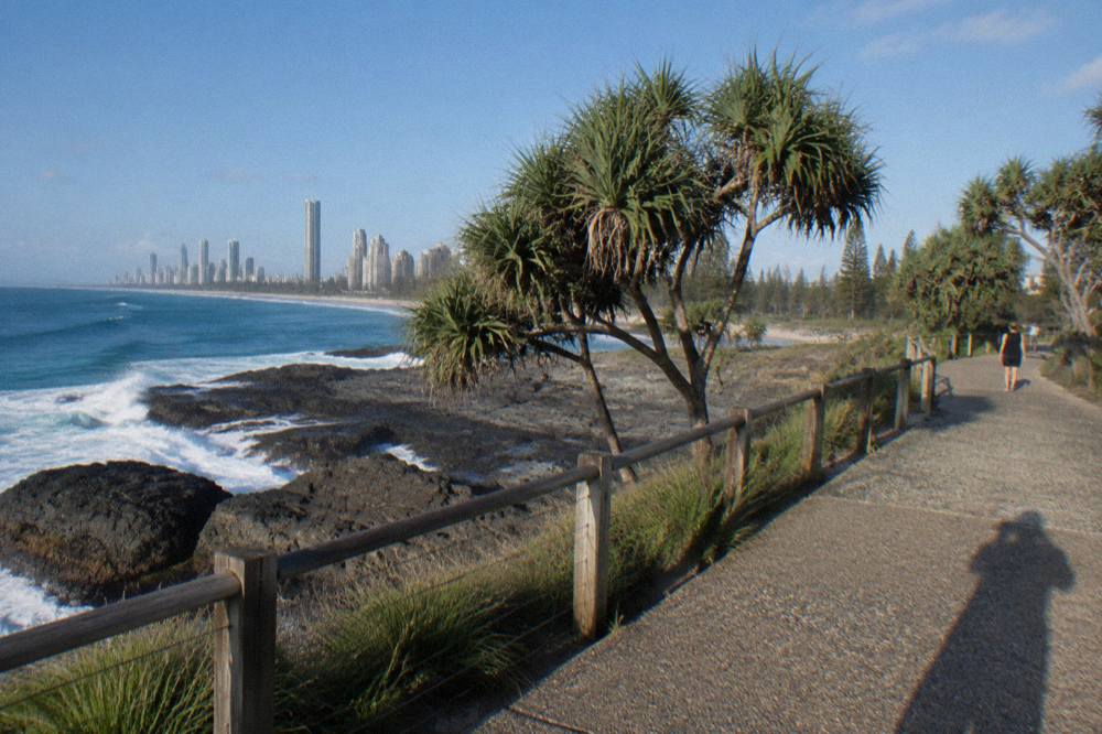 Headland walking track above a rocky shoreline with open ocean beyond