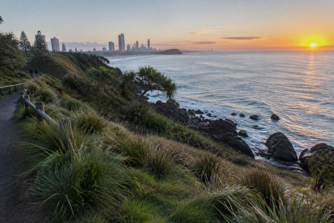 Ocean headland overlooking a calm blue coastline at dawn