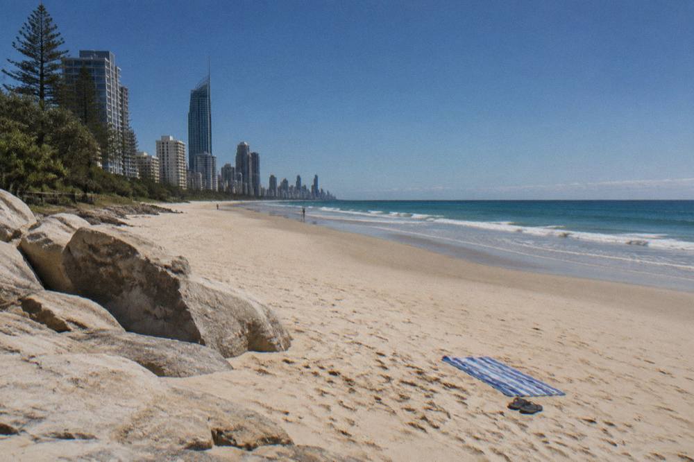 Clear winter sky over calm ocean and a long sand beach