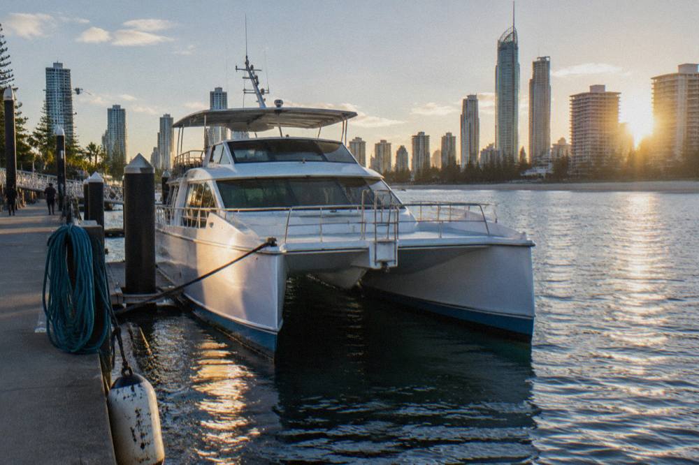 A twin-hulled whale watching catamaran moored at a Southport marina