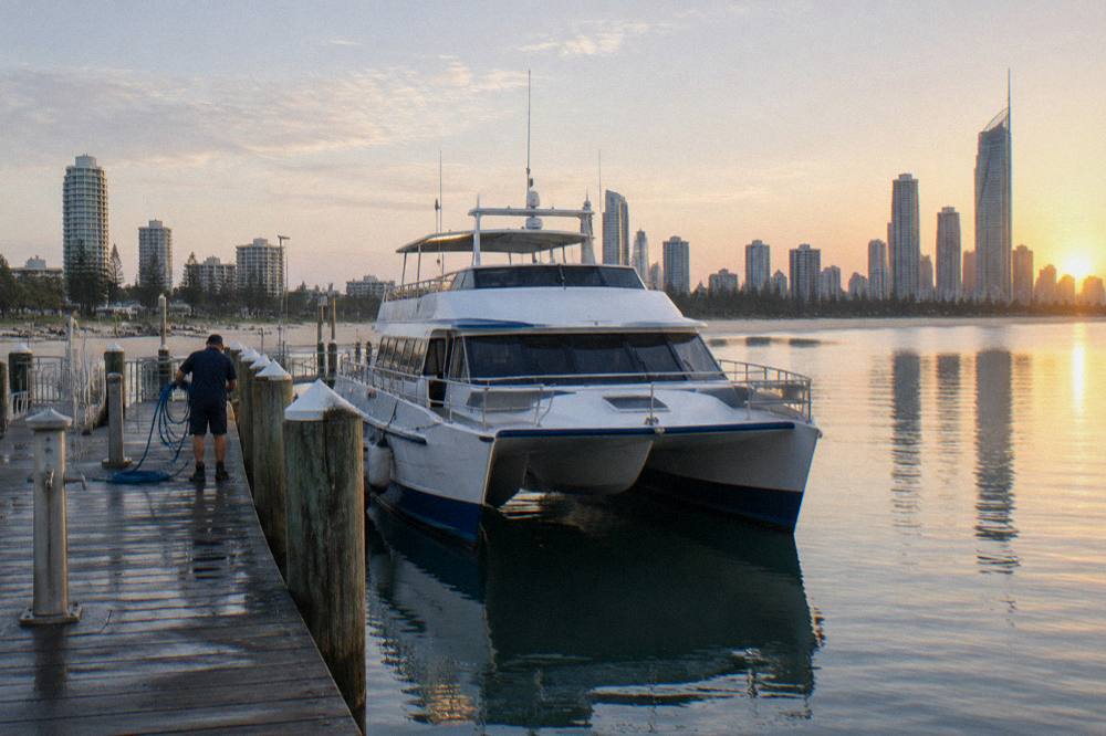 A whale watching catamaran at a marina jetty before departure