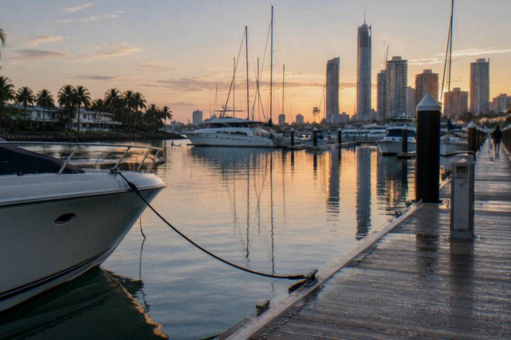 A marina jetty in early light with moored boats and calm water