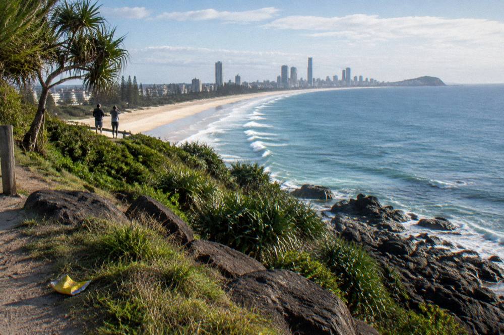 A coastal headland lookout above a long sandy beach in morning light