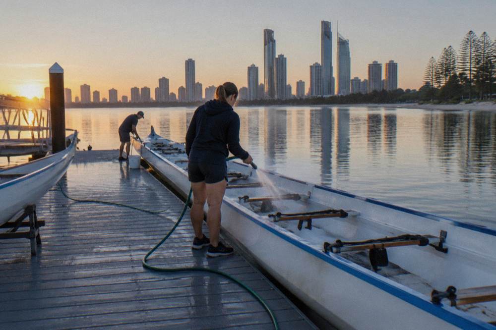 A jetty pontoon on calm water at first light with a boat preparing to depart